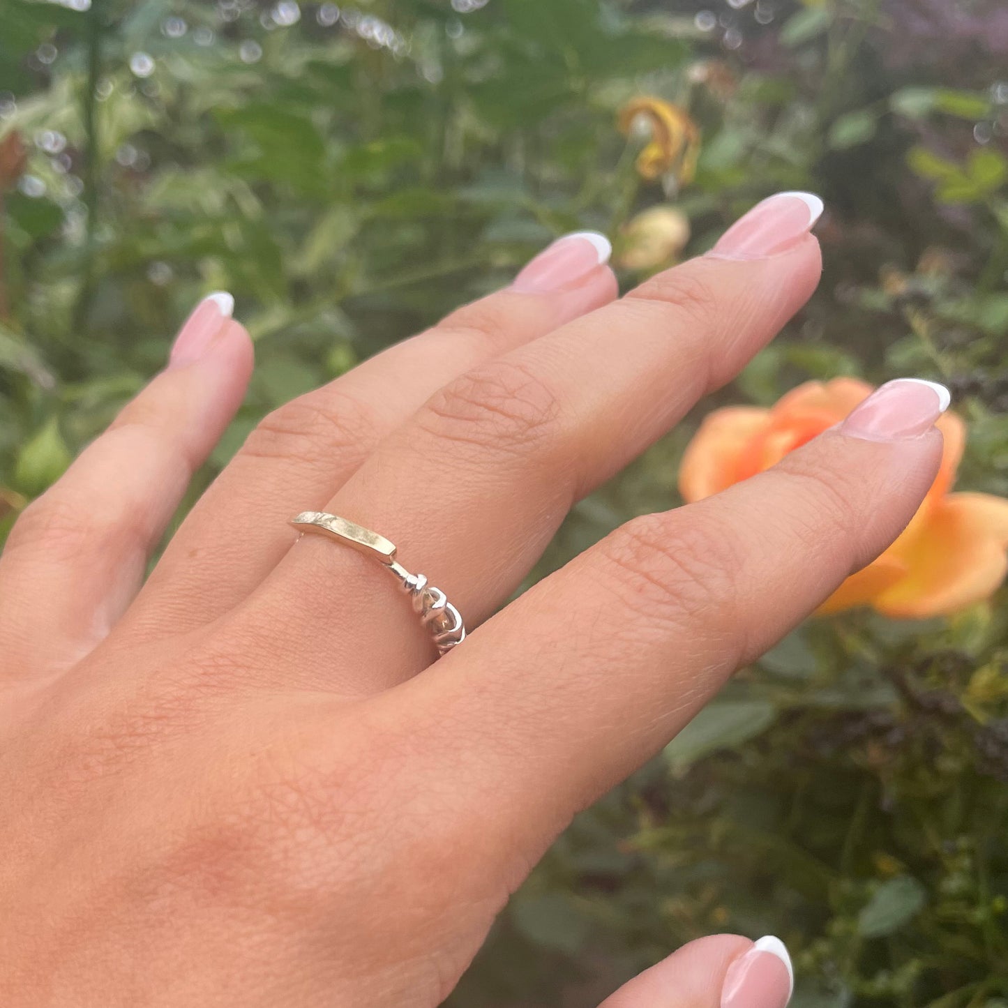 A view on the hand of this beautiful air loom handmade gold ring. The Golden Thread Ring is the first piece of this collection. It is such a flattering and interesting tactile ring to wear. Made of 9ct solid gold bar and wire with the contrasting metal in sterling silver.  Hallmarked by the London Goldsmiths Hall Assay Office and can be made on request in any grade or colour of precious metal.